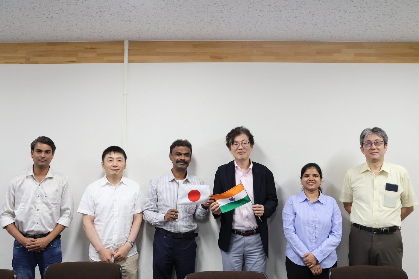 Meeting with collaborators at Osaka Metropolitan University, exchanging Indian and Japanese flags