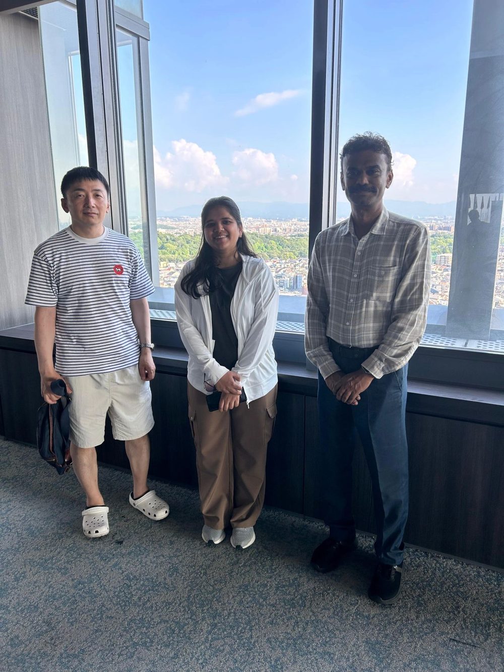 With collaborators overlooking Osaka from a rooftop observation deck